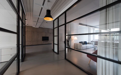 Quiet commercial meeting space behind glass partitions